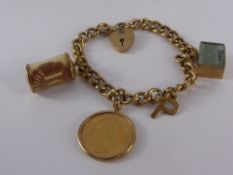 A 9 ct Gold Charm Bracelet, the bracelet with heart shaped clasp, 3 x 9 ct charms and a 1982 full