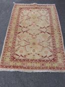 A Persian Woollen Carpet, red floral design on cream ground, approx 120 x 185 cms.