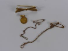 A 9 ct Gold Bow Form Brooch, together with two 9 ct gold safety chains, Jerusalem pendant (2.5 gms),