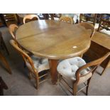 An Edwardian Solid Oak Wind Out Oval Dining Table, on tapered legs and casters, approx 135 x 100 x