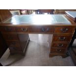 An Oak Office Desk, having four drawers to either side and one large central drawer, supported on