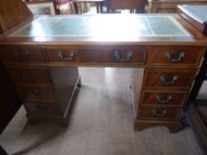 An Oak Office Desk, having four drawers to either side and one large central drawer, supported on