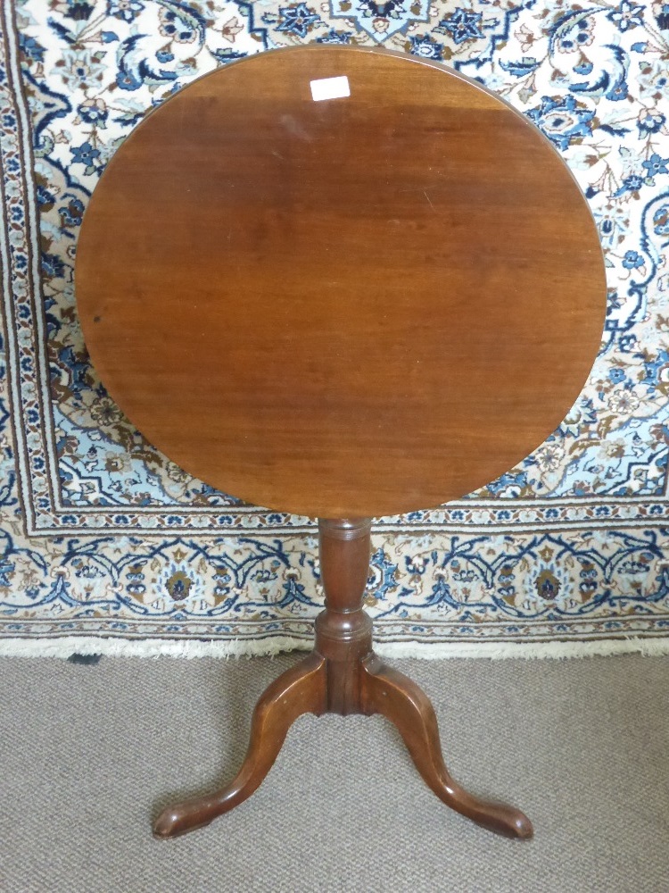 An Antique Mahogany Tilt Top Circular Occasional Table, having turned column support on hoof leg