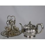 A Silver Plated Egg Cup Stand, with egg cups and spoons together with a tea pot with foliate finial.