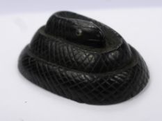 An Antique Japanese Ebony Carved Netsuke, in the form of a coiled snake, with enamel eyes, approx