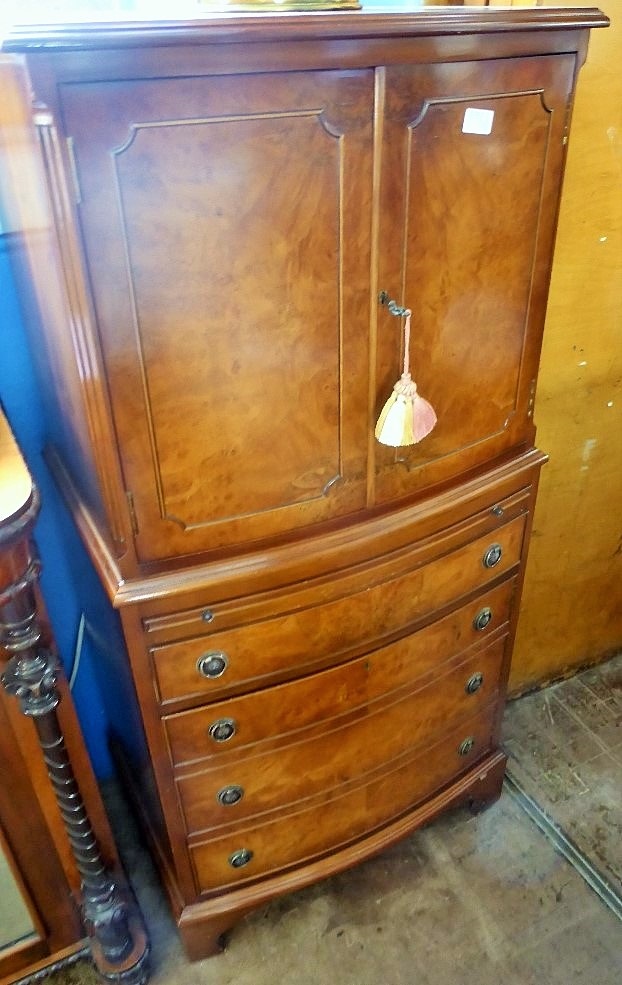 A Walnut Veneer Tallboy, two cupboards with mirrored backs, brush slide, four graduated drawers on