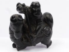 An Antique Japanese Ebony Carved Netsuke, depicting a mounted warrior, approx 4.5 x 4 cms (af)