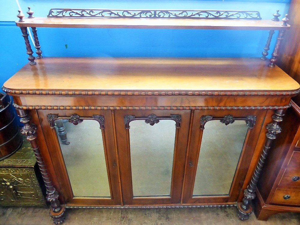 A Mahogany Sideboard, raised gallery with decorative carving, three glazed fronted cupboards