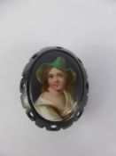 An Antique Jet Mounted Hand Painted Porcelain Miniature Brooch, depicting a young girl, approx 34