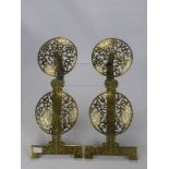A Pair of Regency Brass Fire Dog Fronts, the fronts of a pierced floral shield design, approx 56 x