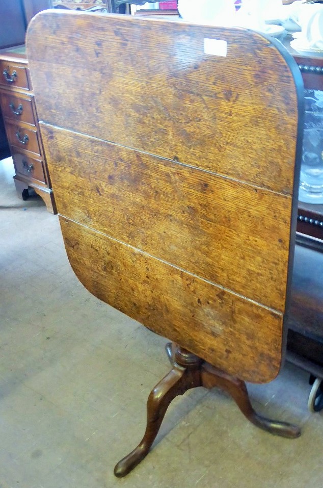 An Antique Oak Tilt Top Table, on tripod pad foot base, approx 65 x 70 x 65 cms.