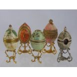 A Collection of Hand Made Italian Decorative Eggs, some with small animals inside, on stands. (11)