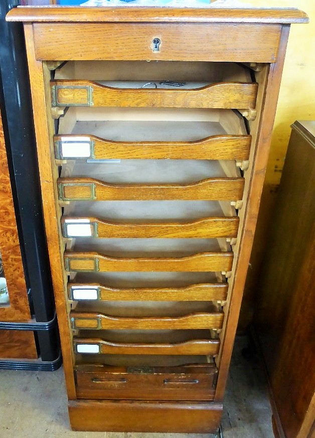 An Oak Art Deco Filing Cabinet, with nine storage drawers behind a tambour slide front, approx 37