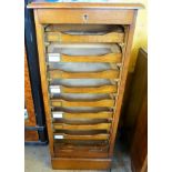 An Oak Art Deco Filing Cabinet, with nine storage drawers behind a tambour slide front, approx 37