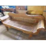 A Hardwood Empire Style Rattan Seated Couch, the couch having shaped legs with carved swan neck