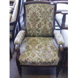 A Victorian Arm Chair, with swept back on turned legs and brass casters, tapestry covering.