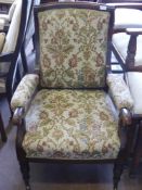 A Victorian Arm Chair, with swept back on turned legs and brass casters, tapestry covering.