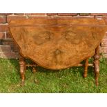 A 19th Century Walnut Veneer Drop Leaf Table, on ornately carved legs and stretchers, approx 109 x