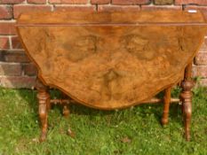 A 19th Century Walnut Veneer Drop Leaf Table, on ornately carved legs and stretchers, approx 109 x