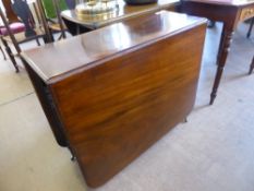 A Mahogany Drop Leaf Dining Table, on turned legs and brass casters, approx 91 x 163 x 74 cms.