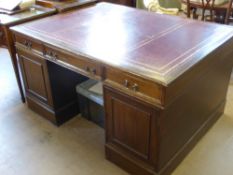 A Mahogany Partner's Desk, with three drawers and two cupboards beneath to either side, a burgundy