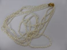 A Lady's Seed Four Strand Pearl Necklace, with floral clasp, approx 60 cms long.