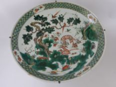 A Pair of 19th Century Famile Vert Chargers, the first depicting two peacocks amongst prunus and