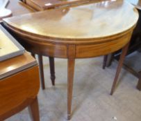 An Edwardian Folding Card Table, with burgundy baize and decorative inlay, on tapered legs (wf),