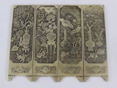 A Set of Four Solid Silver Chinese Scroll Weights, the weights having various floral scenes