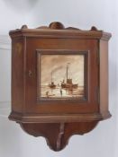 An Edwardian Mahogany Miniature Corner Cabinet, the cabinet having a hand painted tile to front,