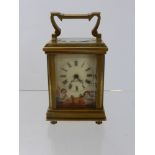 A Miniature French Brass Hand Painted Carriage Clock, porcelain side panels depicting cherubs