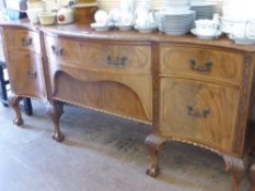 An Edwardian Mahogany Serpentine Sideboard, benefiting from two side drawers, central cutlery