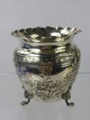 A Silver Vase, embossed with floral decoration, Birmingham hallmark, supported on three claw feet,