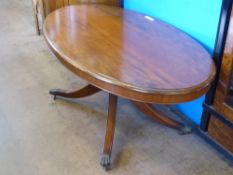 A Mahogany Oval Coffee Table, turned column on splayed legs, approx 124 x 71 x 54 cms.