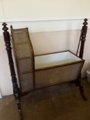 A Late Victorian Mahogany Framed Woven Cane Infant's Crib, the crib suspended from a turned column