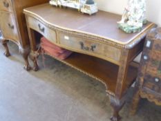 An Edwardian Bow Fronted Serving Buffet, having two drawers with shelf below, carved floral border