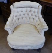 A Victorian Tub Chair, with button back upholstery, turned legs and casters.