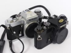 A Nikon EL2 7833434 35 mm Camera Body, together with a Nikon FE3935535 Camera body. (2) Note: