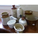 A Quantity of Stoneware, including two jelly moulds and four vintage hot water bottles.