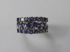 A Lady's 9 ct White Gold Tanzanite Ring, 16 x 2.6 mm and 6 x 4.6 x 2.6 mm tanz, size K, approx 3.4