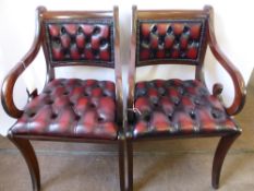 A Pair of Reproduction Dining Chairs, with studded red leather seats and back rest, on splayed