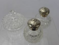 Two Cut Glass Silver Topped Dressing Table Bottles, together with a cut glass cotton wool jar and