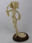 An 'Amilcare Santini' Faux Ivory Figurine, of an elegant lady on an oak plinth, approx 50 cms high