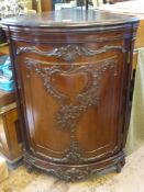 A Mahogany French Bow Fronted Corner Cabinet, having carved wooden front, raised on carved legs,