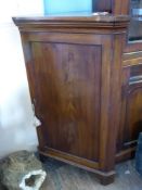 A Mahogany Corner Cupboard, panel door revealing three internal shelves, approx 67 x 38 x 110 cms.