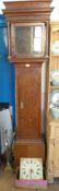 An Antique Long Case Clock. The clock having an oak case with a mahogany column support and having