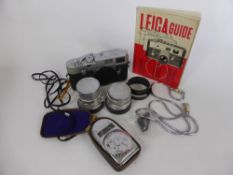 A Vintage Leica DBP Ernst Leitz Wetzlar Model M2-93417 Camera Body, together with Lenses,