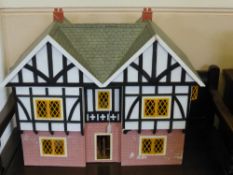 A Wooden Doll's House, with many fittings and furniture, approx 73 x 55 x 35 cms.