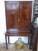 An Antique Mahogany Glass Cabinet on Stand. The cabinet having reeded supports with brass campaign