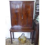 An Antique Mahogany Glass Cabinet on Stand. The cabinet having reeded supports with brass campaign